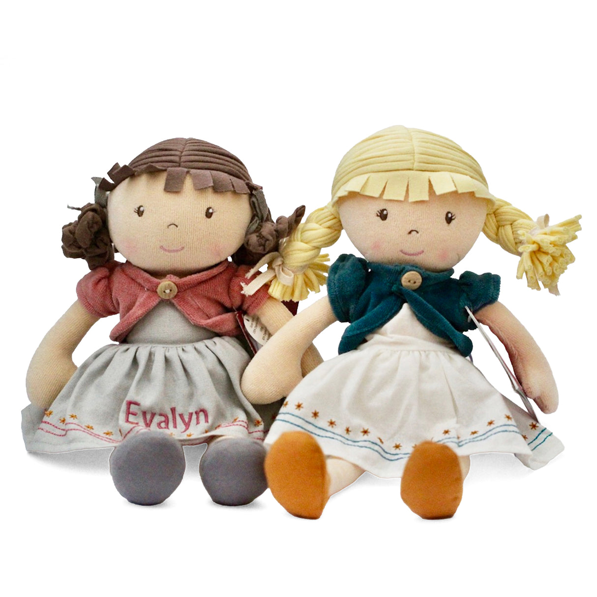 Two dolls with different hairstyles and clothing on a white background