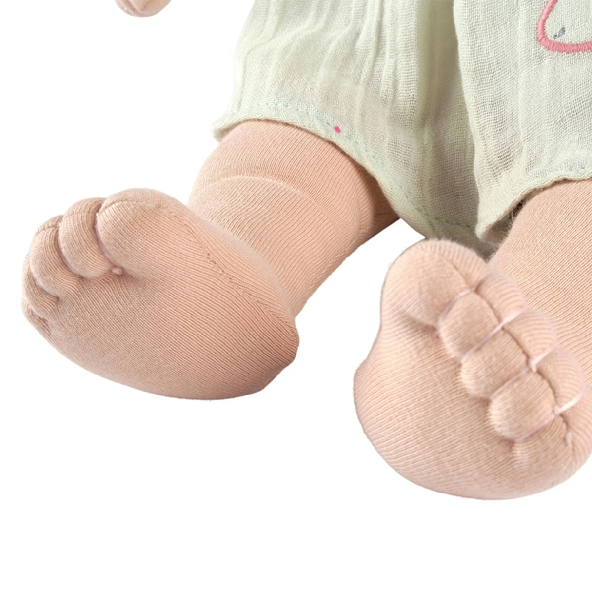 Baby rab doll legs and feet on a white background