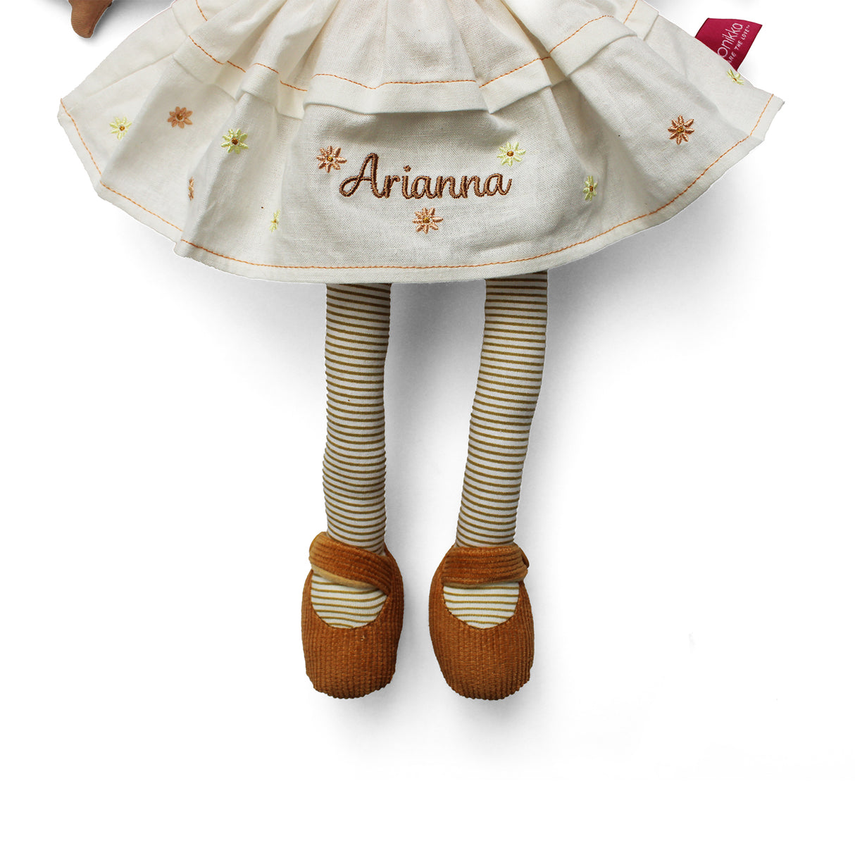 Plush soft rag doll with name personalised on the cream dress which has brown and yellow flowers. The doll also has brown and cream stripey tights and brown shoes on a white background