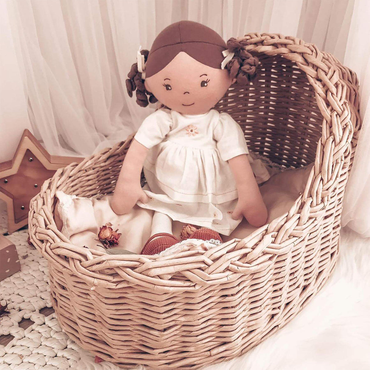 Rag doll in a wicker basket with a soft, blurred background
