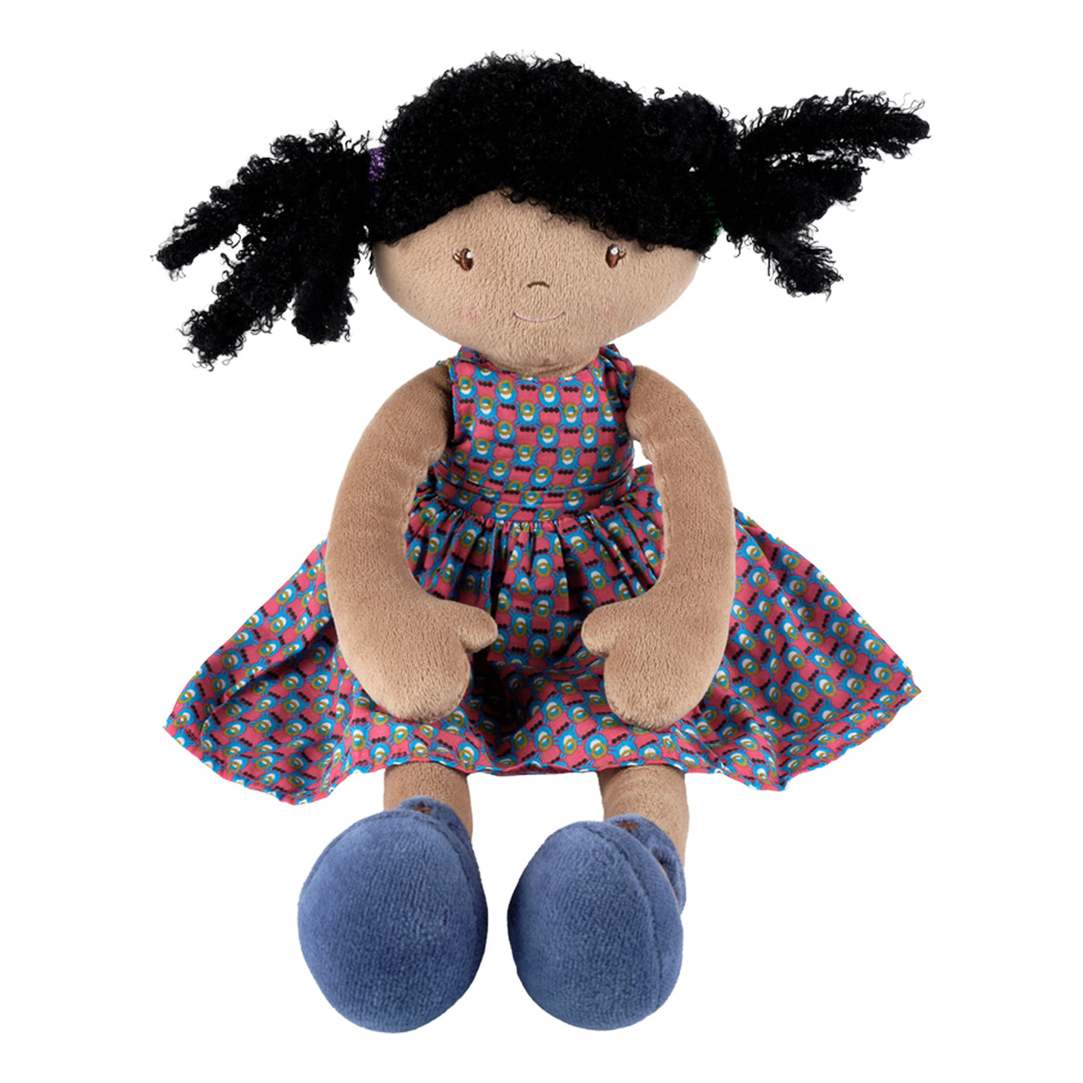 Plush soft doll with black hair, blue,red and black patterned dress, and blue shoes on a white background