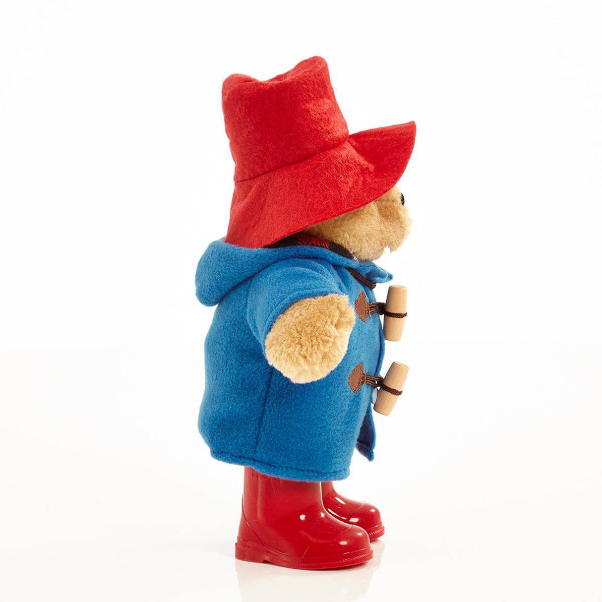 Classic Paddington Bear soft toy with red hat, blue coat with wooden toogles andred boots.