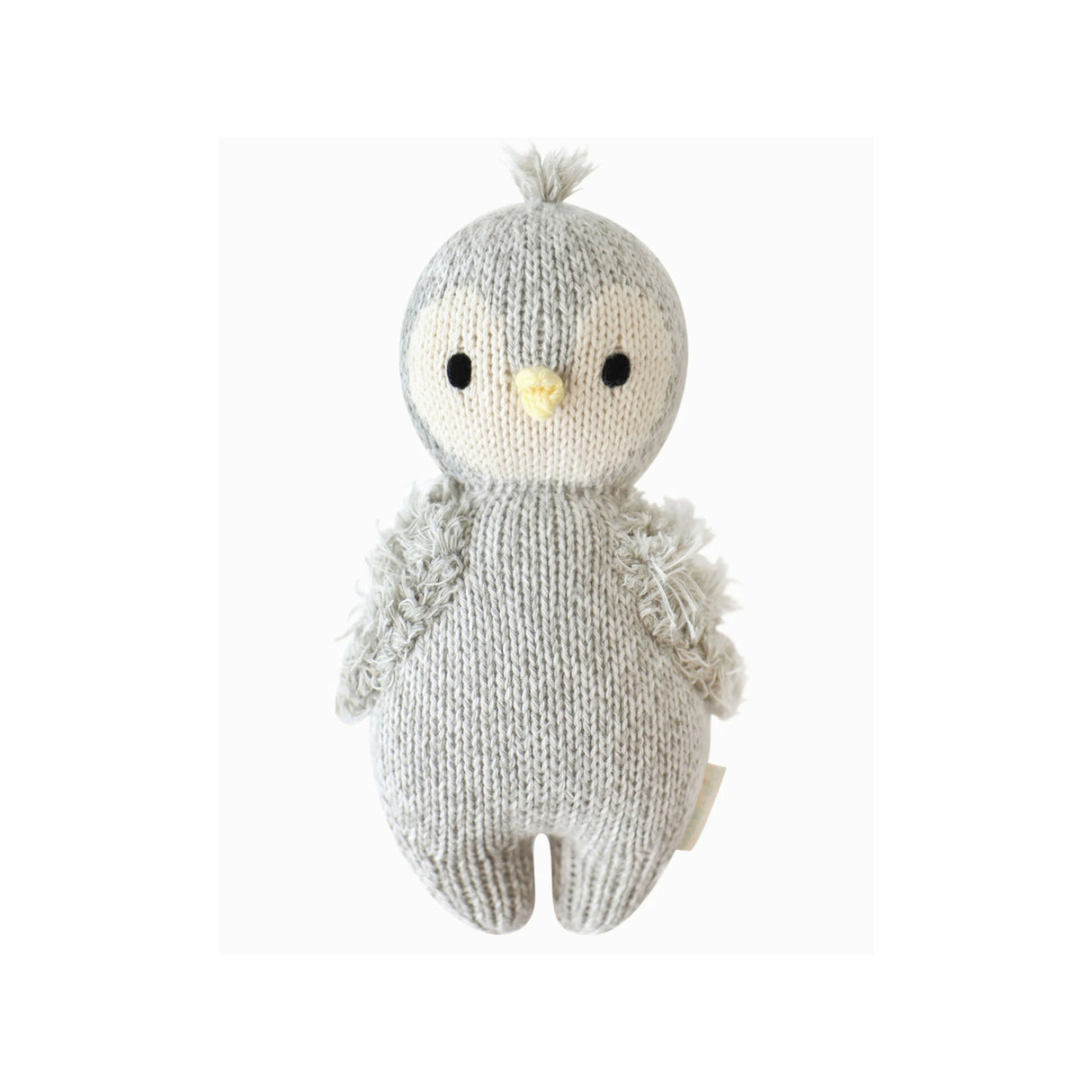 Handknitted baby penguin soft toy on a white background