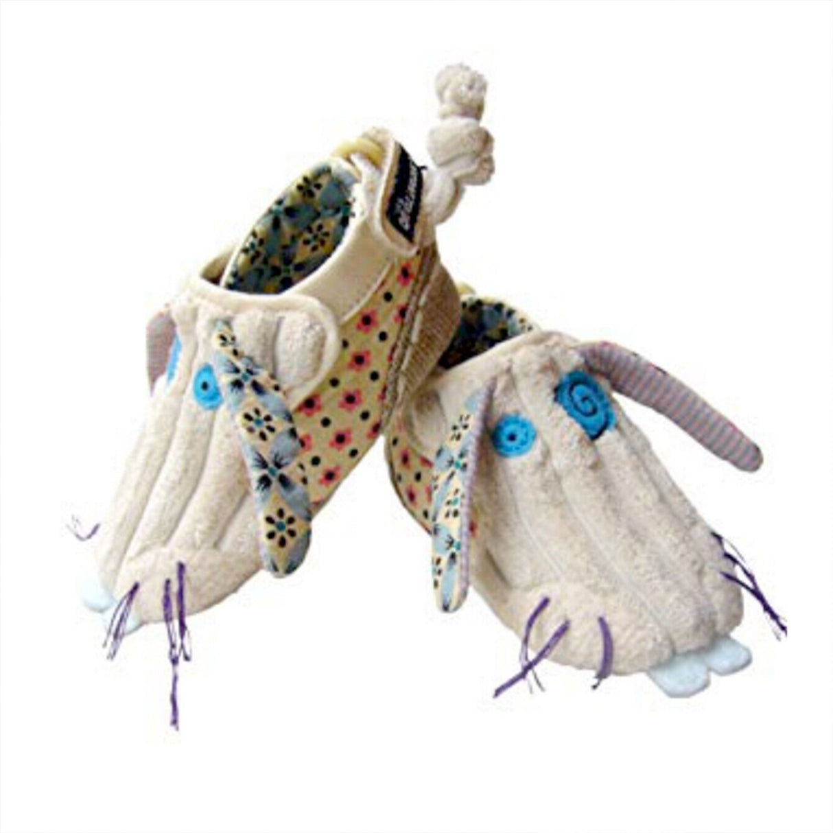 A pair of beige baby booties with blue and purple details, designed to look like a bunny face and tail, with adjustable velcro fasteners.
