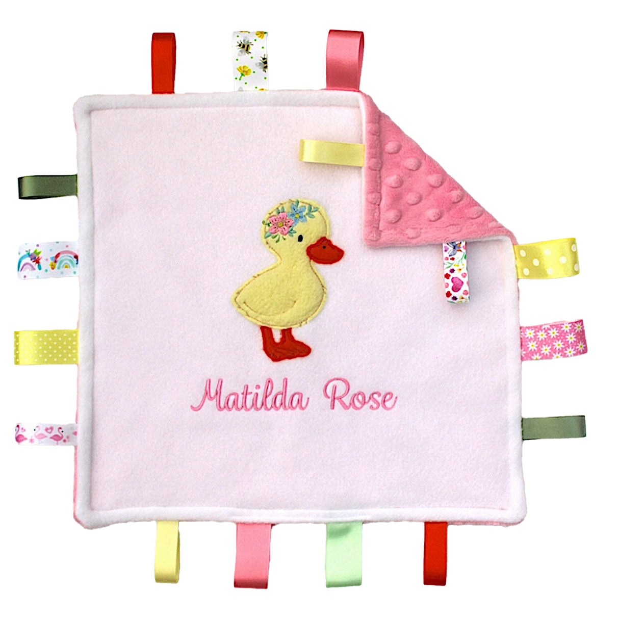 Handmade baby comfort taggy blanket with a duckling design and colourful tags on a white background