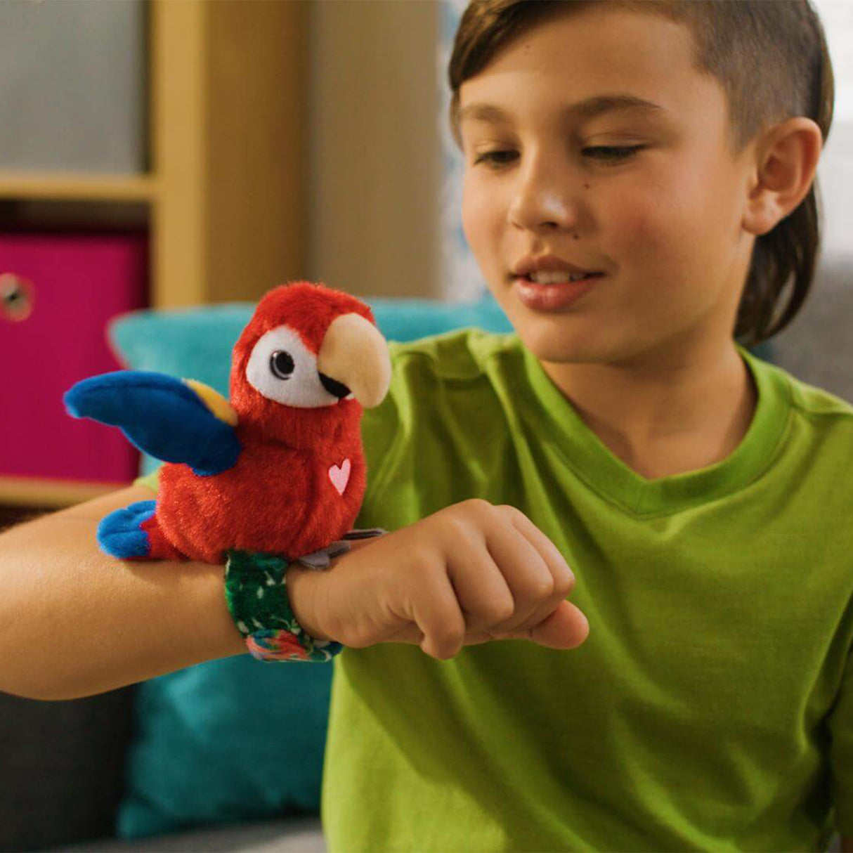 Child wearing a red parrot-shaped toy on a wristband