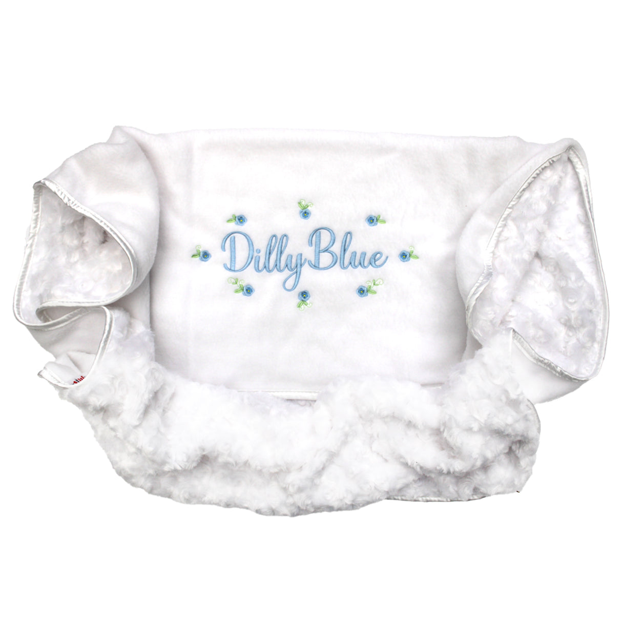 White blanket with personalised embroiderd name with blue flowers on a white background