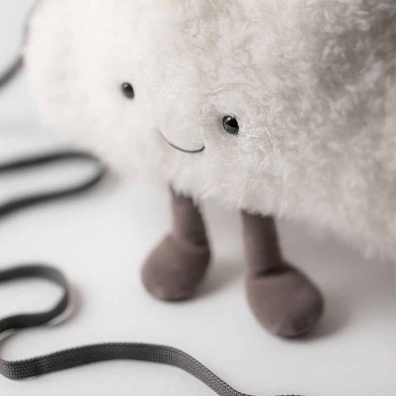 A plush white cloud-shaped bag with a smiling face and grey cordy legs, attached to a grey strap.