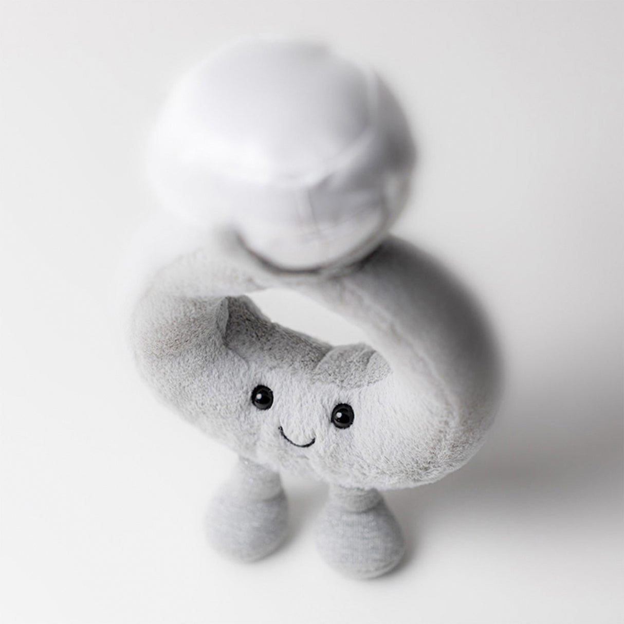 Jellycat Plush dimond ring shaped toy with a face on a white background