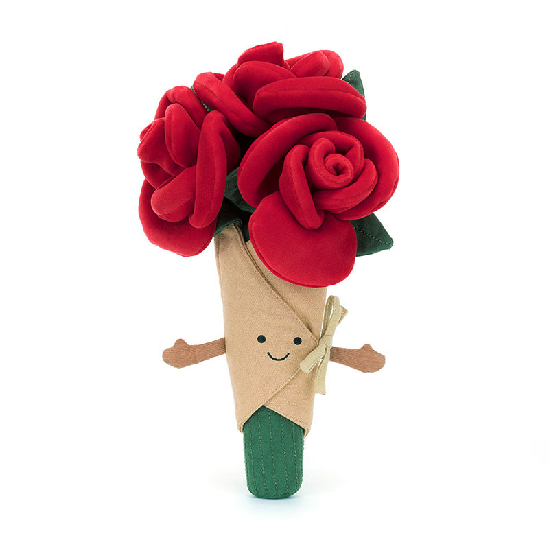 A plush toy bouquet of roses with soft red petals, green leaves, and stems, wrapped in beige linen with a smiling face embroidered on the front.