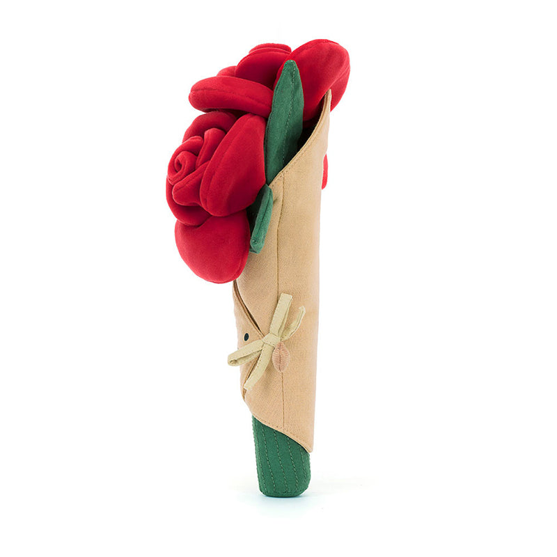 A plush toy bouquet of roses with soft red petals, green leaves, and stems, wrapped in beige linen with a smiling face embroidered on the front.