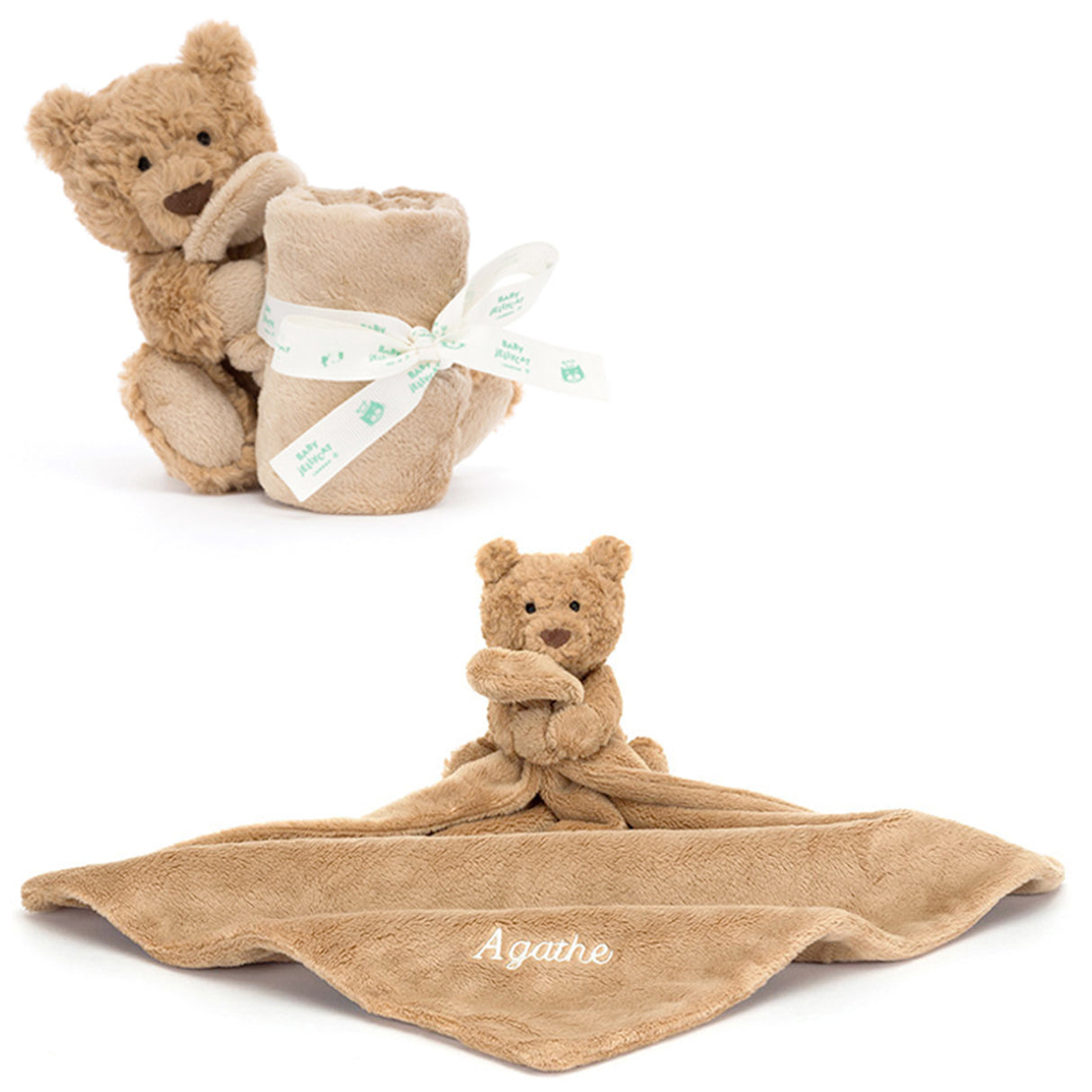 A plush toy bear holding a square-shaped soother, with a ribbon bow and a name tag attached to the soother.
