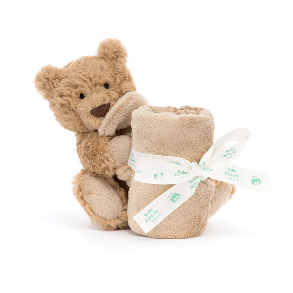 Stuffed teddy bear holding a sootherl with a white ribbon on a white background