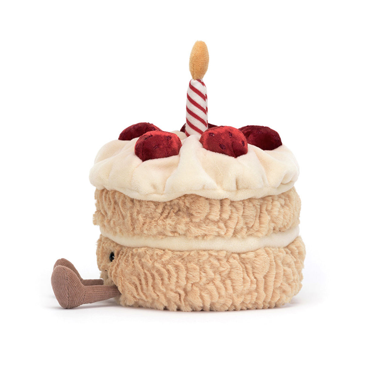 A plush toy resembling a birthday cake with a smiling face, decorated with a red and white candle