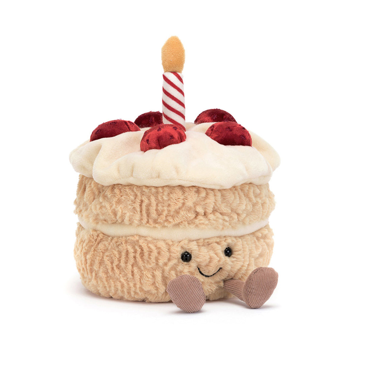 A plush toy resembling a birthday cake with a smiling face, decorated with a red and white candle