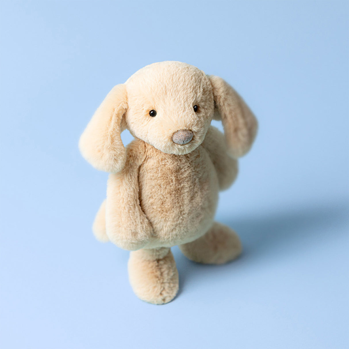 Bashful Luxe Puppy Orlando Original Plush toy dog on a light blue background