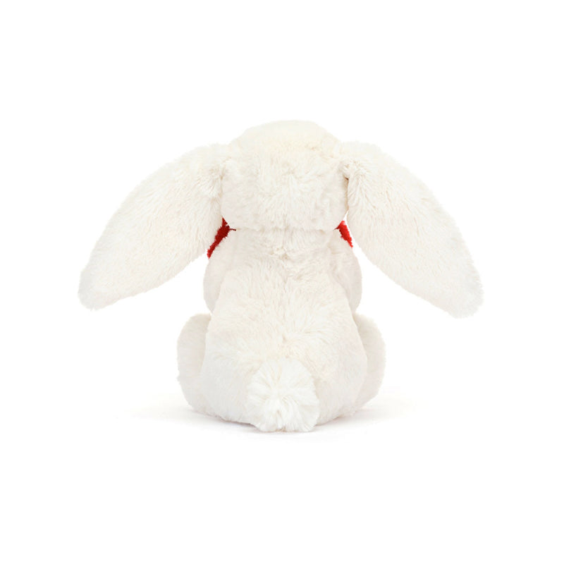 A plush toy of a white bunny holding a red love heart.