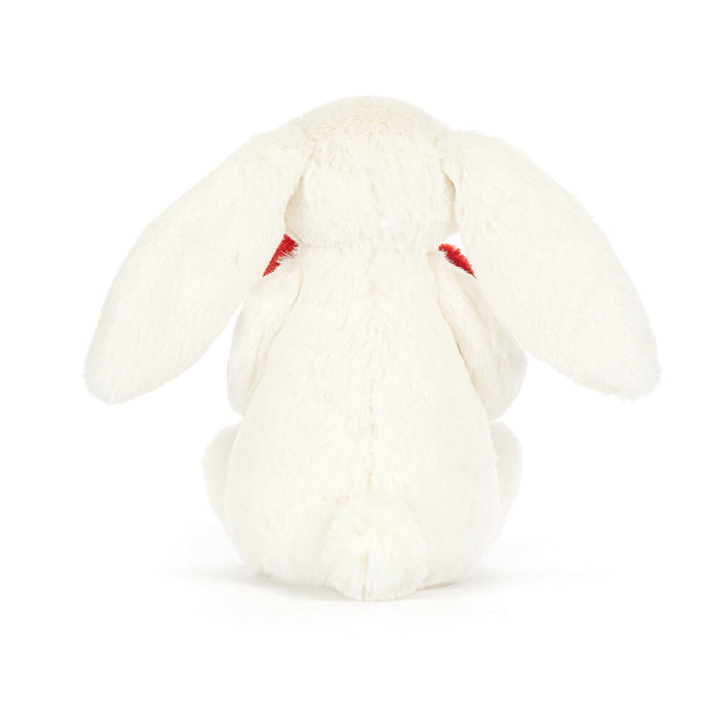 A plush toy of a white bunny holding a red love heart.