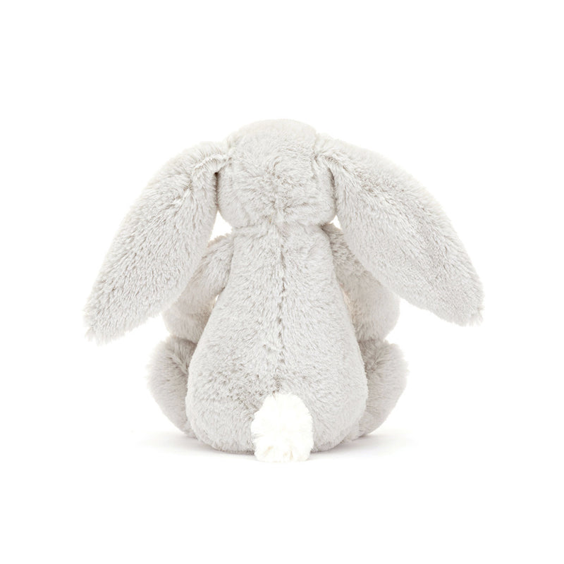 A small plush toy resembling a gray bunny with floral patterns on its ears and feet, and a white backdrop.