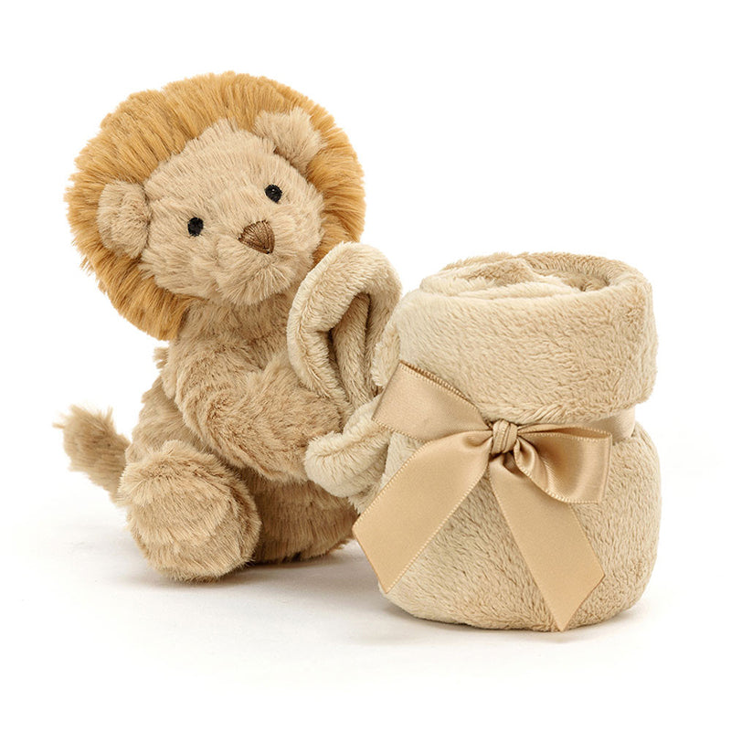 A plush toy depicting a lion with a beige mane and cream-brûlé fur, holding and cuddling a beige soother blanket