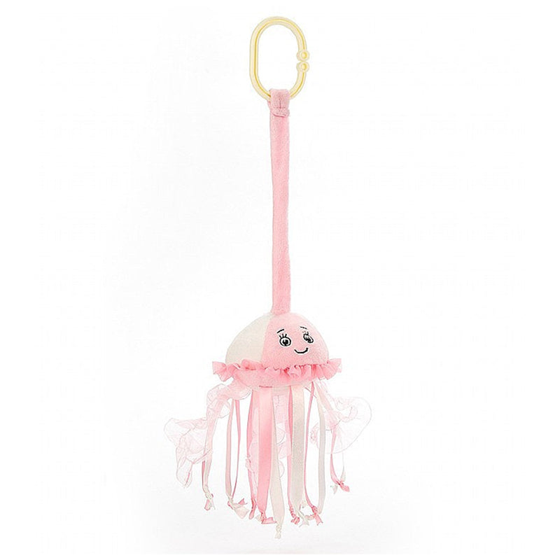 A pink Jellycat sea streamer jellyfish jitter with a smiling face and frilled tentacles, complete with a yellow ring for attachment.