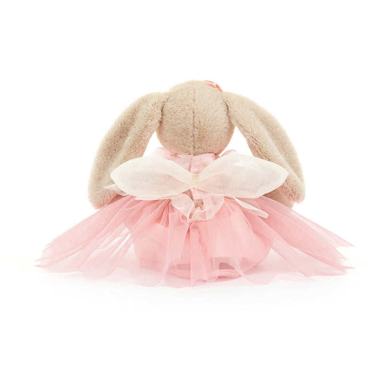 A plush toy resembling a beige bunny with pink ballet attire, including a tutu and bow, sitting against a white background.