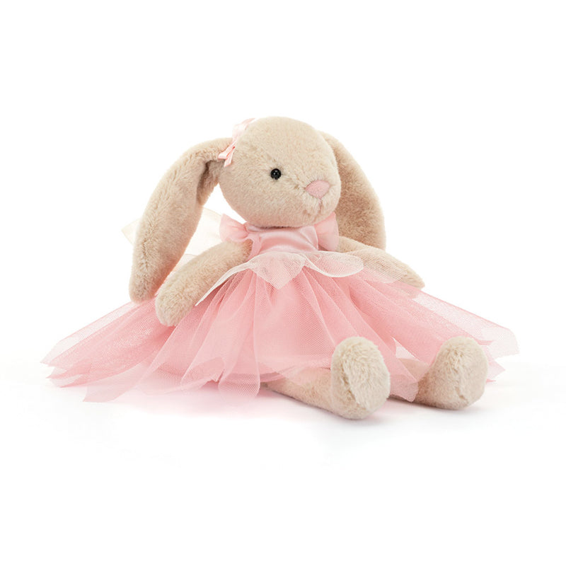 A plush toy resembling a beige bunny with pink ballet attire, including a tutu and bow, sitting against a white background.