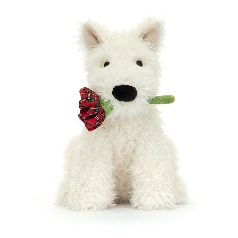 A plush toy depicting a white-coloured dog with a black suedette nose, holding a red tartan rose in its mouth.