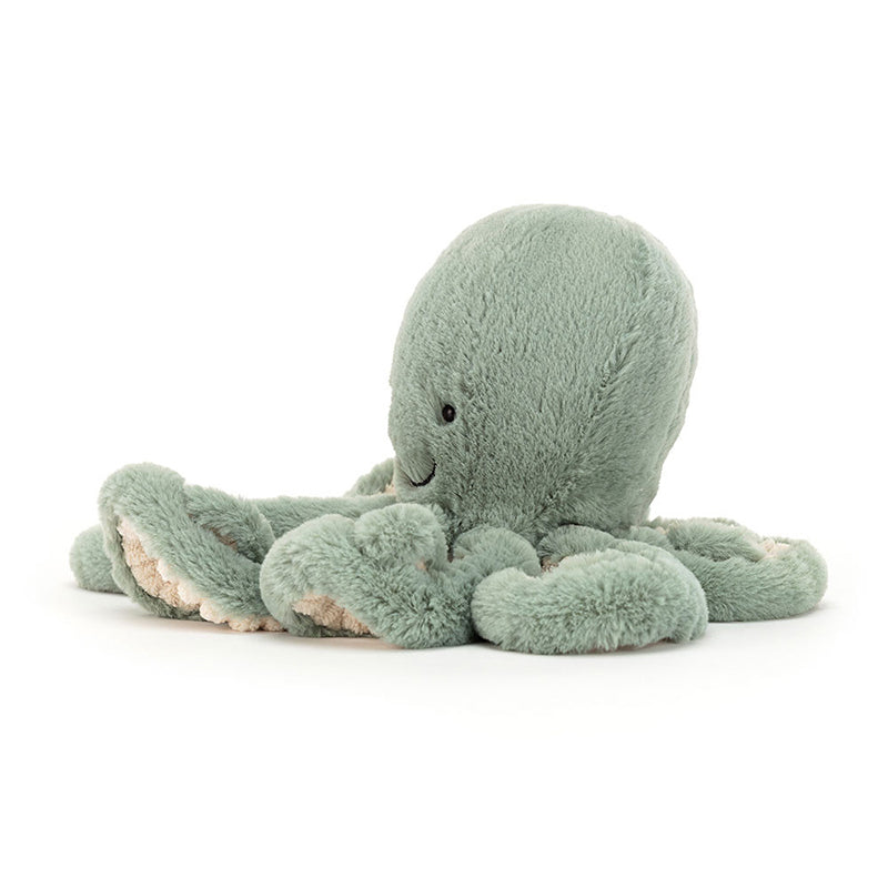 A soft toy resembling an octopus with a sage green color and cream fur beneath. It has eight tentacles and a smiling face.