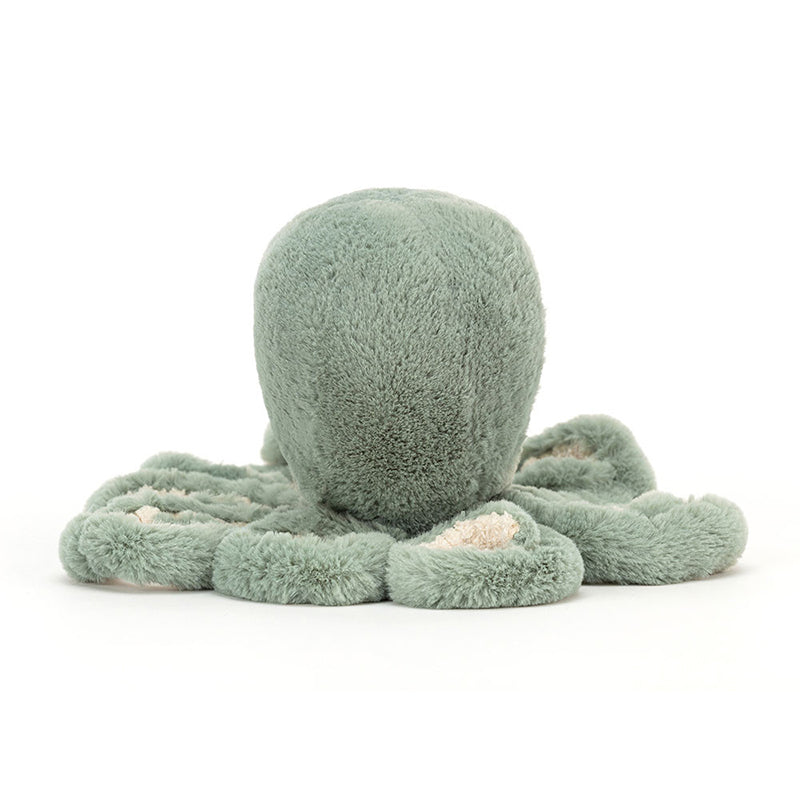 A soft toy resembling an octopus with a sage green color and cream fur beneath. It has eight tentacles