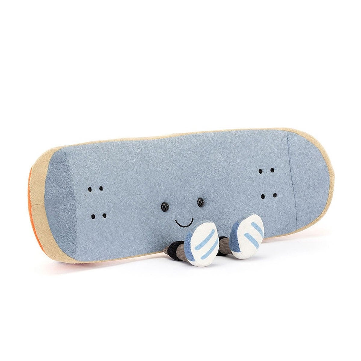 A plush toy in the shape of a skateboard with a smiling face. It has blue fabric with beige edging and orange details.