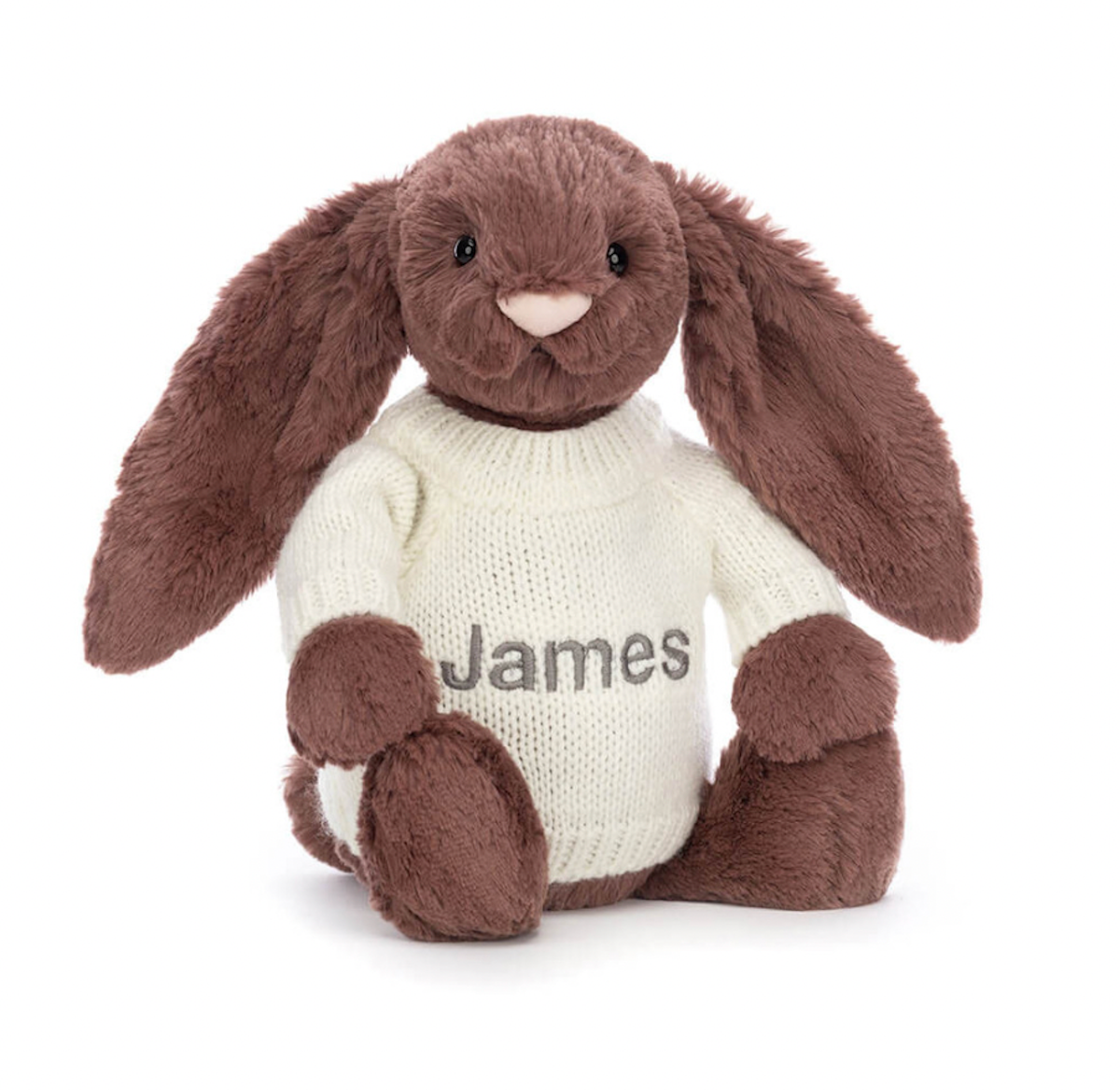 A beige plush toy in the shape of a bunny with long ears, wearing a white jumper with the name 'James' embroidered on the back.