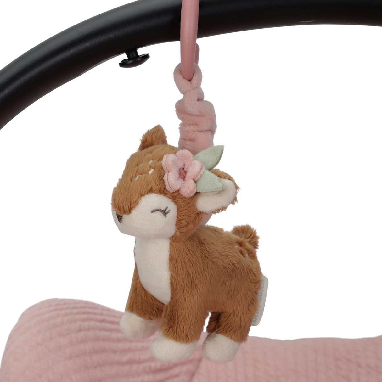Plush deer toy with a flower headband hanging from a pink ribbon against a white background.