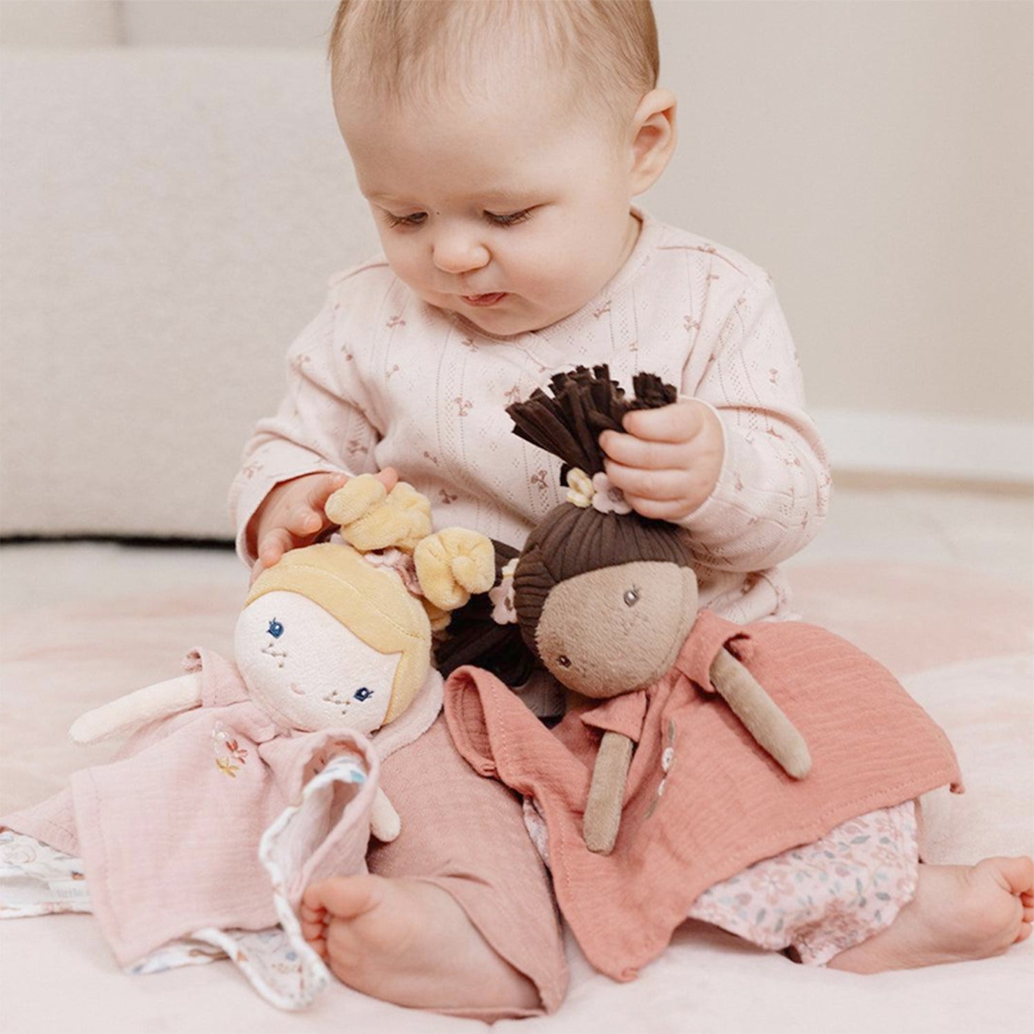 Baby playing with Little Duth Plush toy fairy dolls cuddle cloth with pink floral design