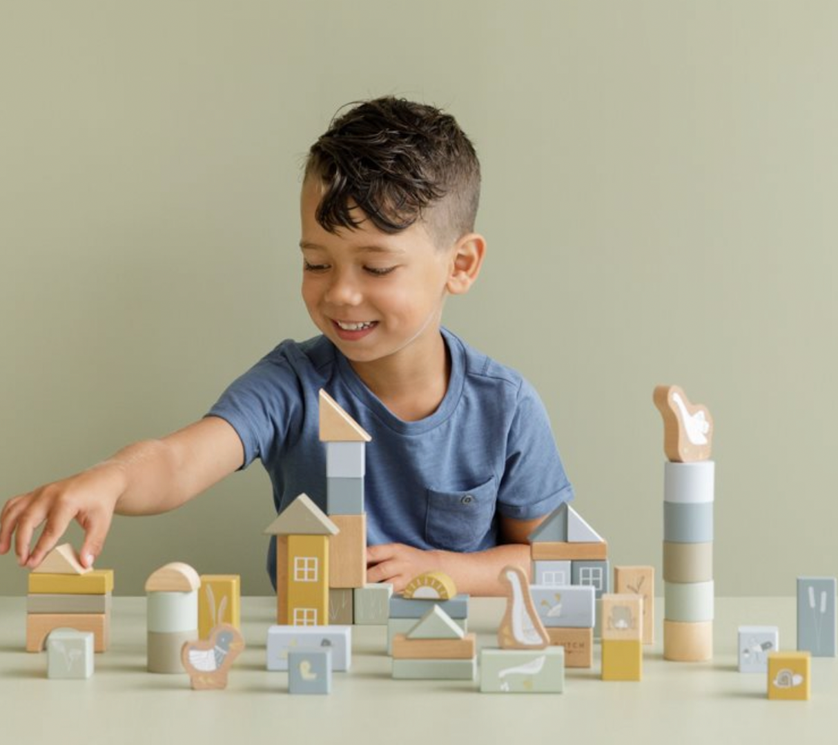 A collection of wooden building blocks in various shapes and sizes, decorated with characters.The blocks are in shades of blue, beige, and different colours representing different characters.