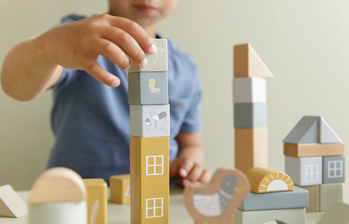 Stacked illustrated wooden building blocks in various colours