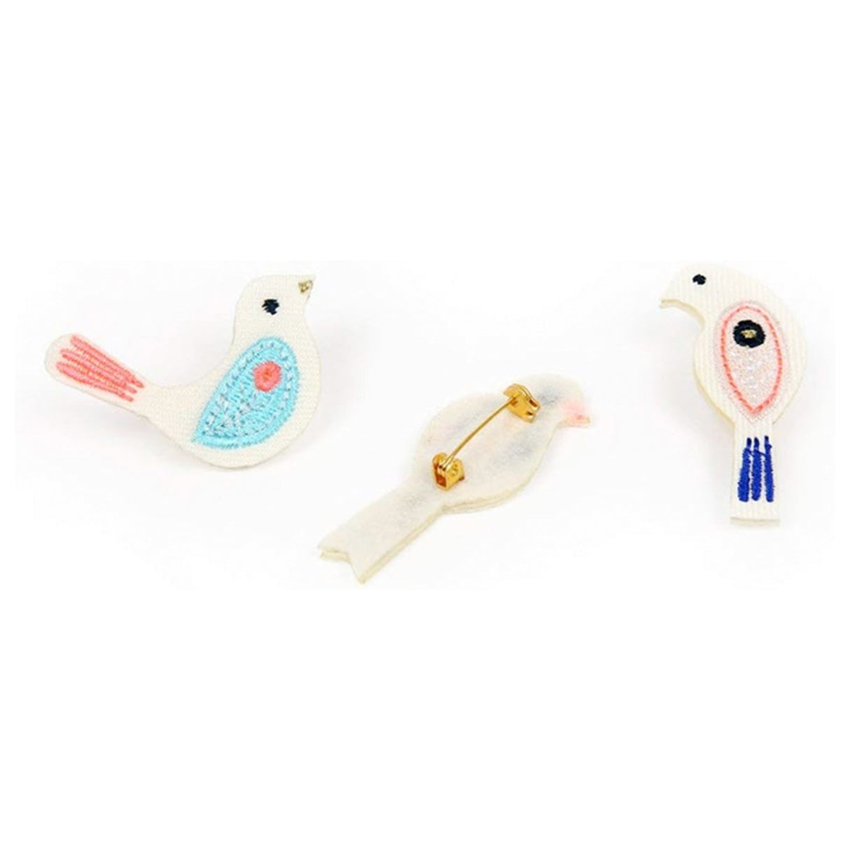 Three bird-shaped brooches on a white background
