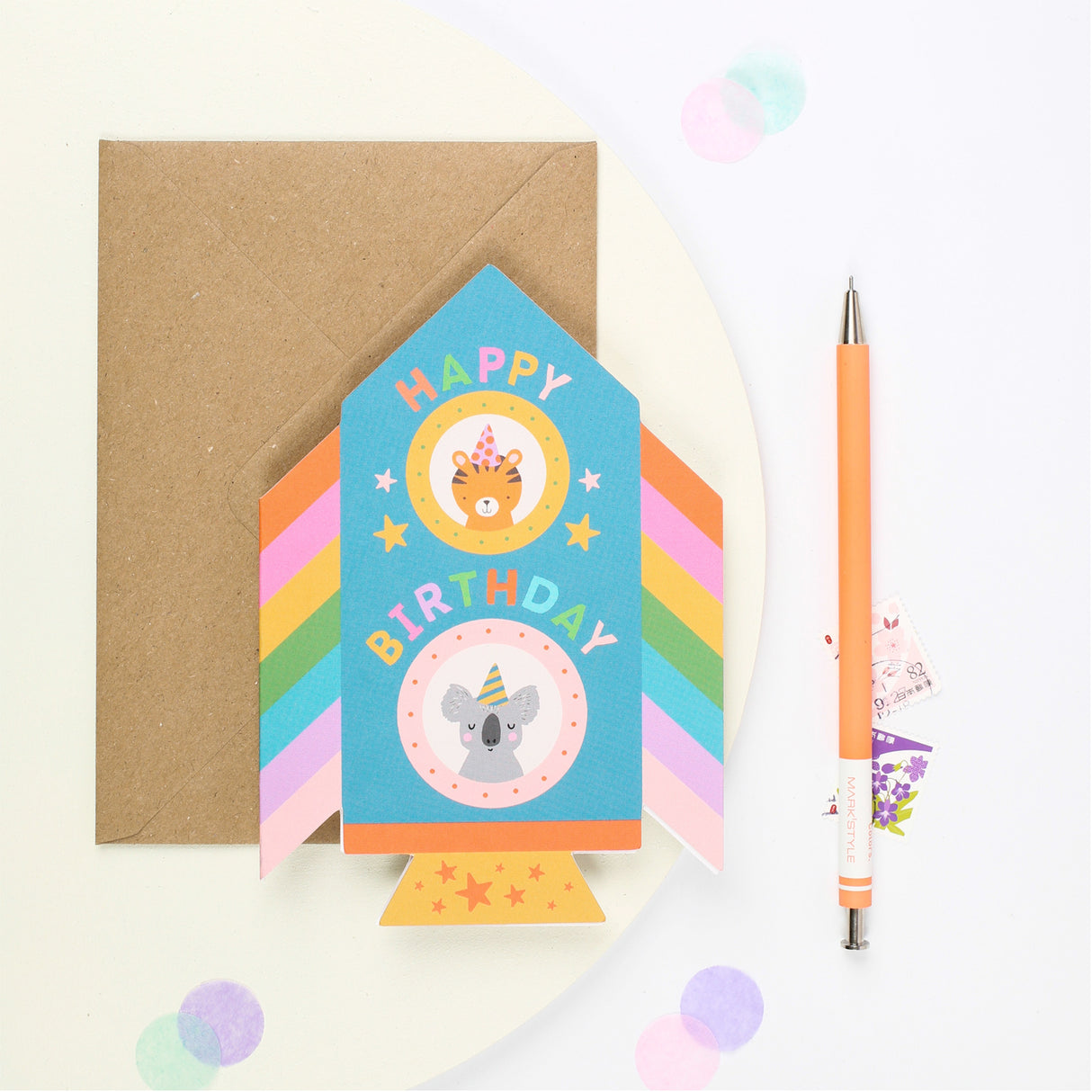 Colorful childrens Rocket birthday card with a pen on a white background