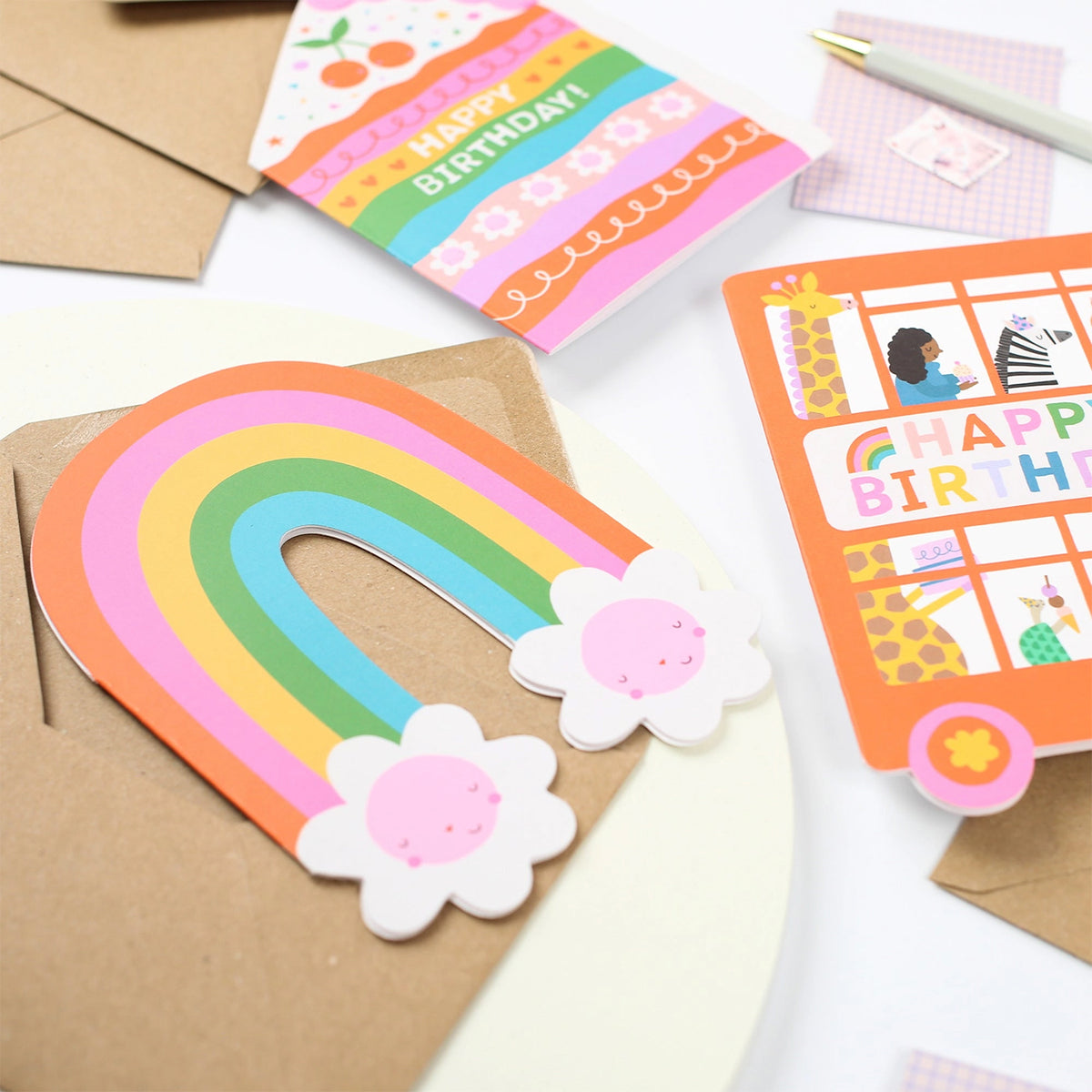 Close-up of Mifkins Rainbow Blossom Birthday Card showing rainbow arch and smiling flower details