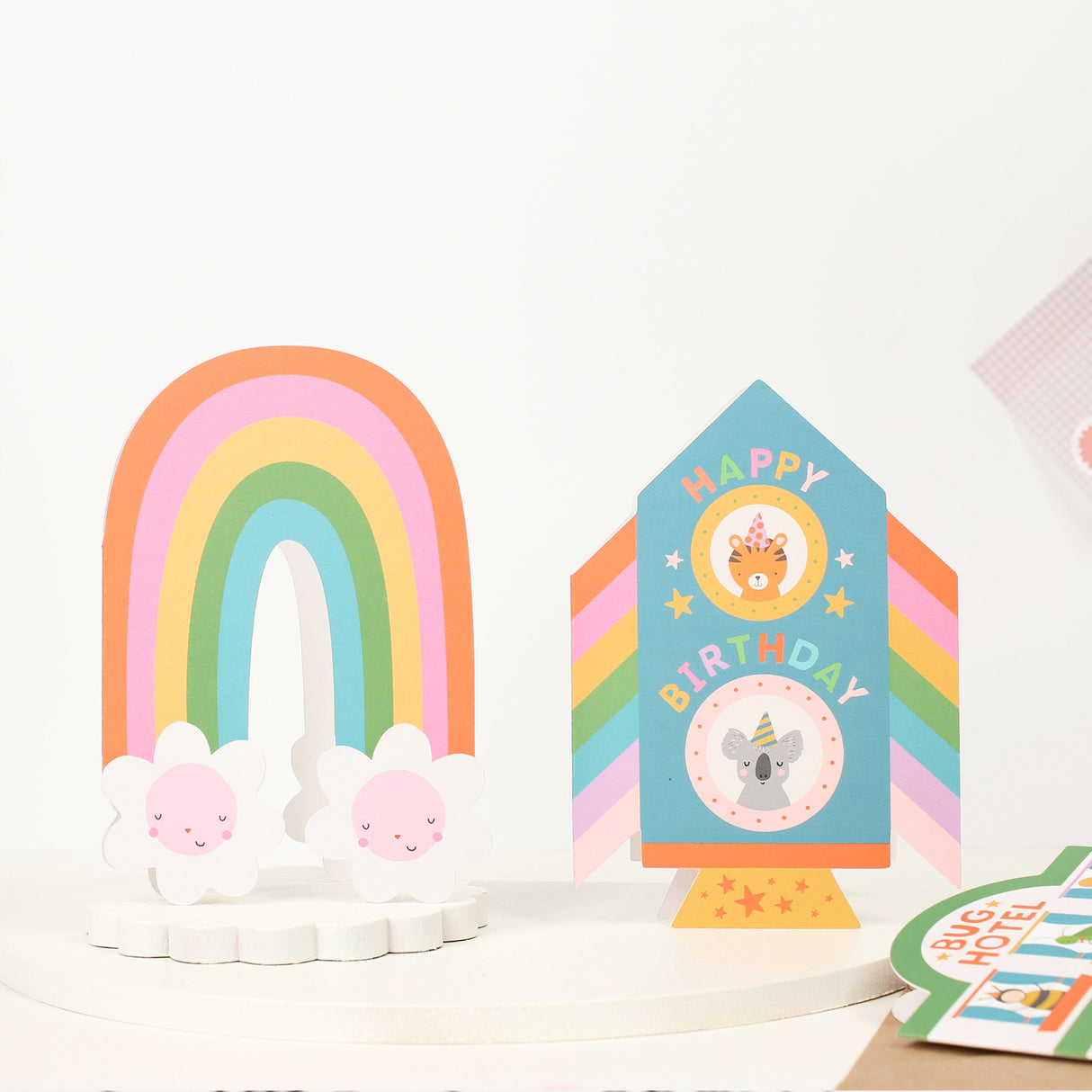 Colourful birthday card with rainbow and rocket design and animal illustrations on a white background