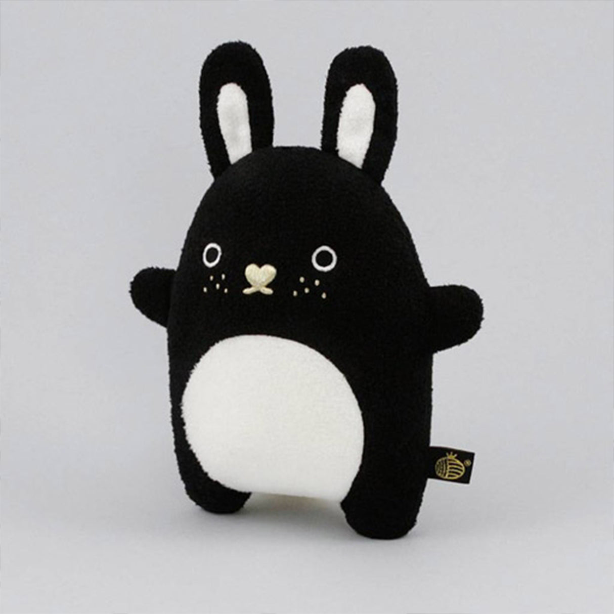 Black and white bunny soft toy with gold heart shaped nose, freckles and white belly
