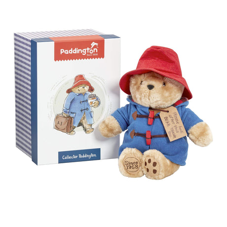 Paddington bear toy with red hat and blue coat next to its packaging
