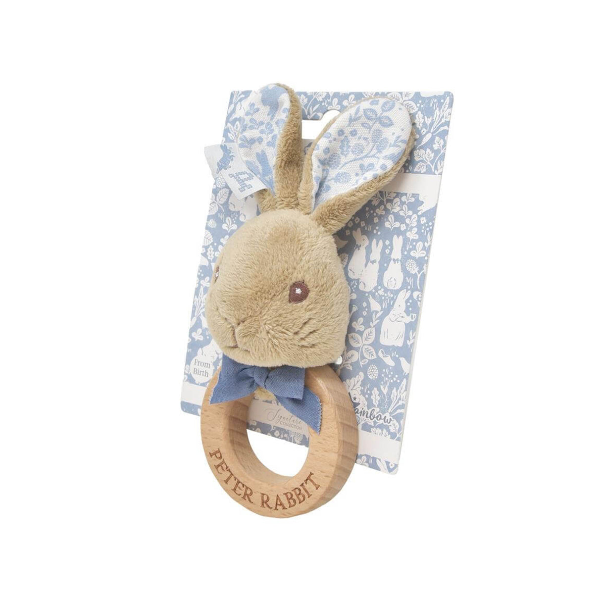 Plush rabbit teething ring with wooden ring on a floral patterned blanket