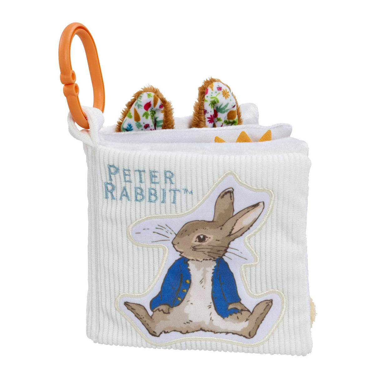 Side view of the Rainbow Designs Peter Rabbit fold out activity book showing white corduroy cover, Peter Rabbit embroidered title, fluffy ear tabs and orange clip