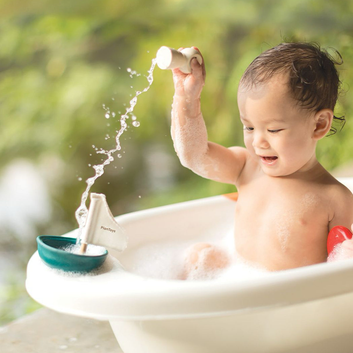 Child playing with a bath toy outdoors