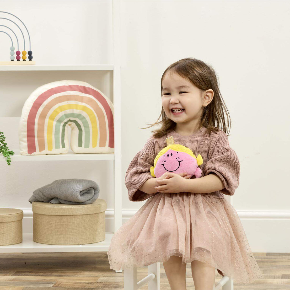 Litlle girl in room holding Little Miss Princess