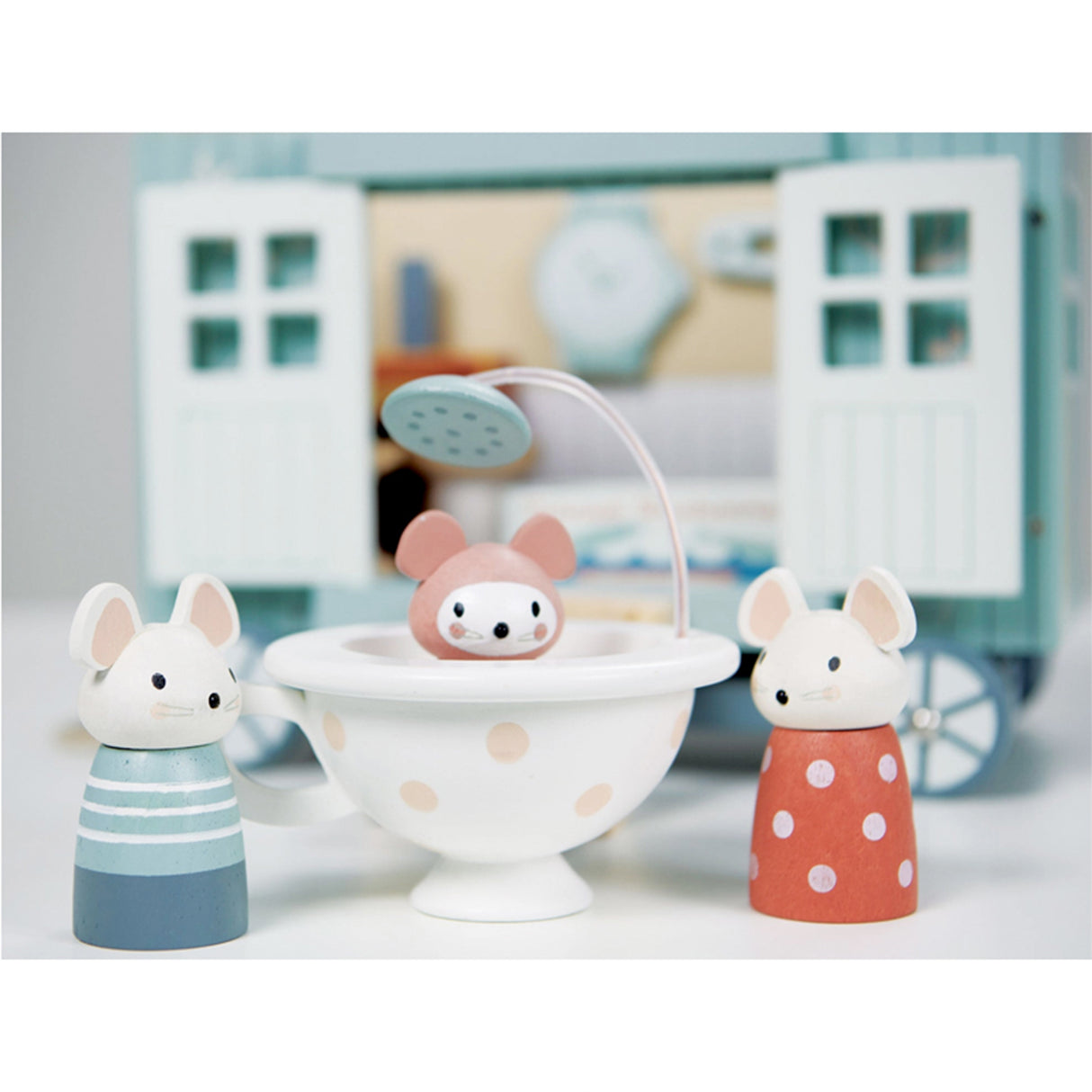 Three small wooden animal figurines with a shower in a toy-like setting
