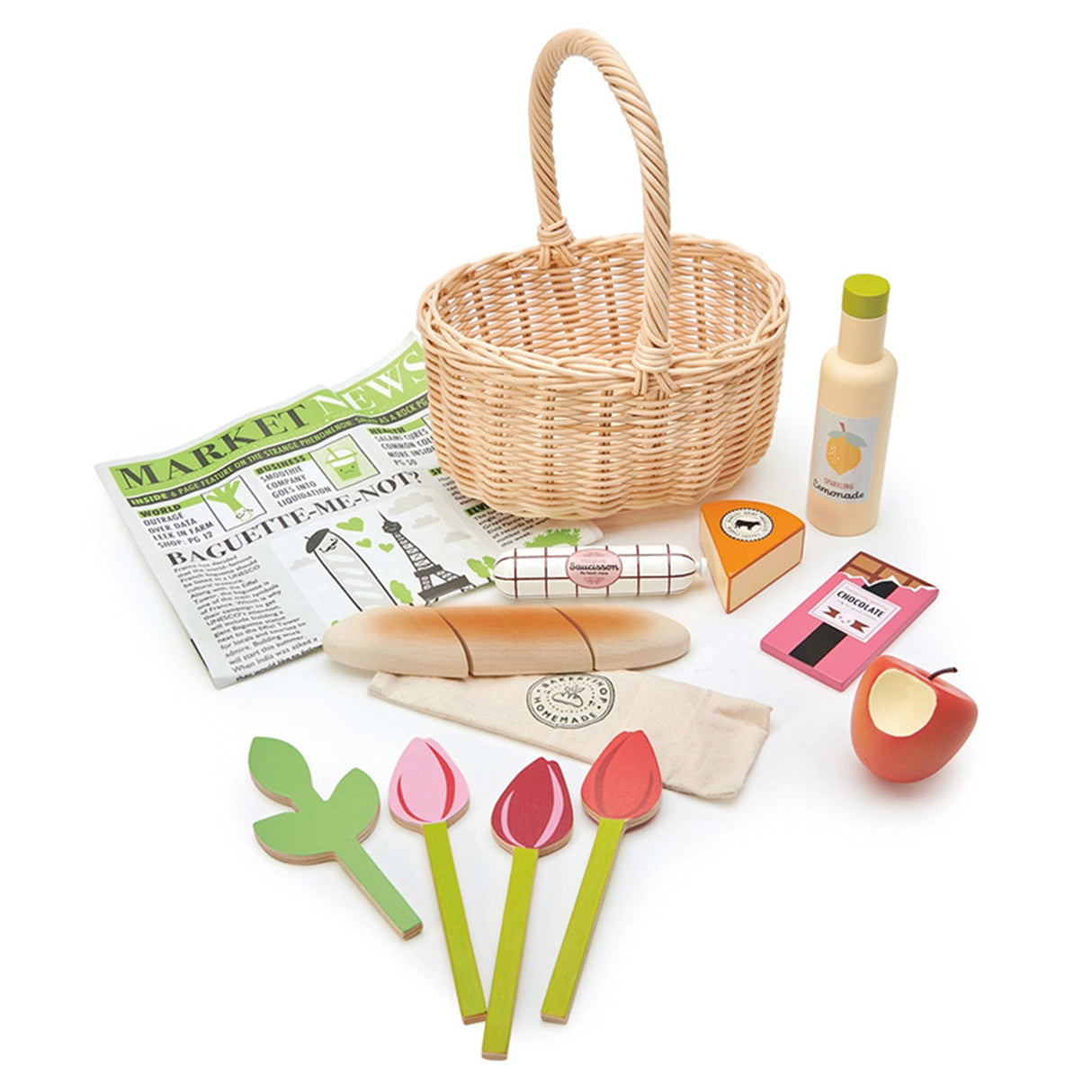 Toy picnic set with wicker basket, food items, and newspaper on a white background