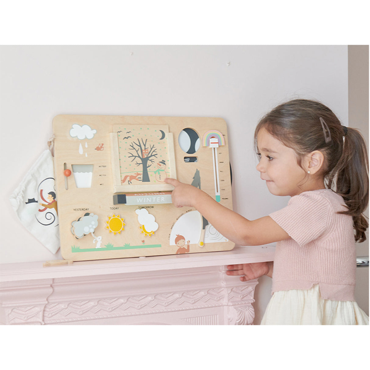 Child interacting with a wooden educational toy on a shelf.