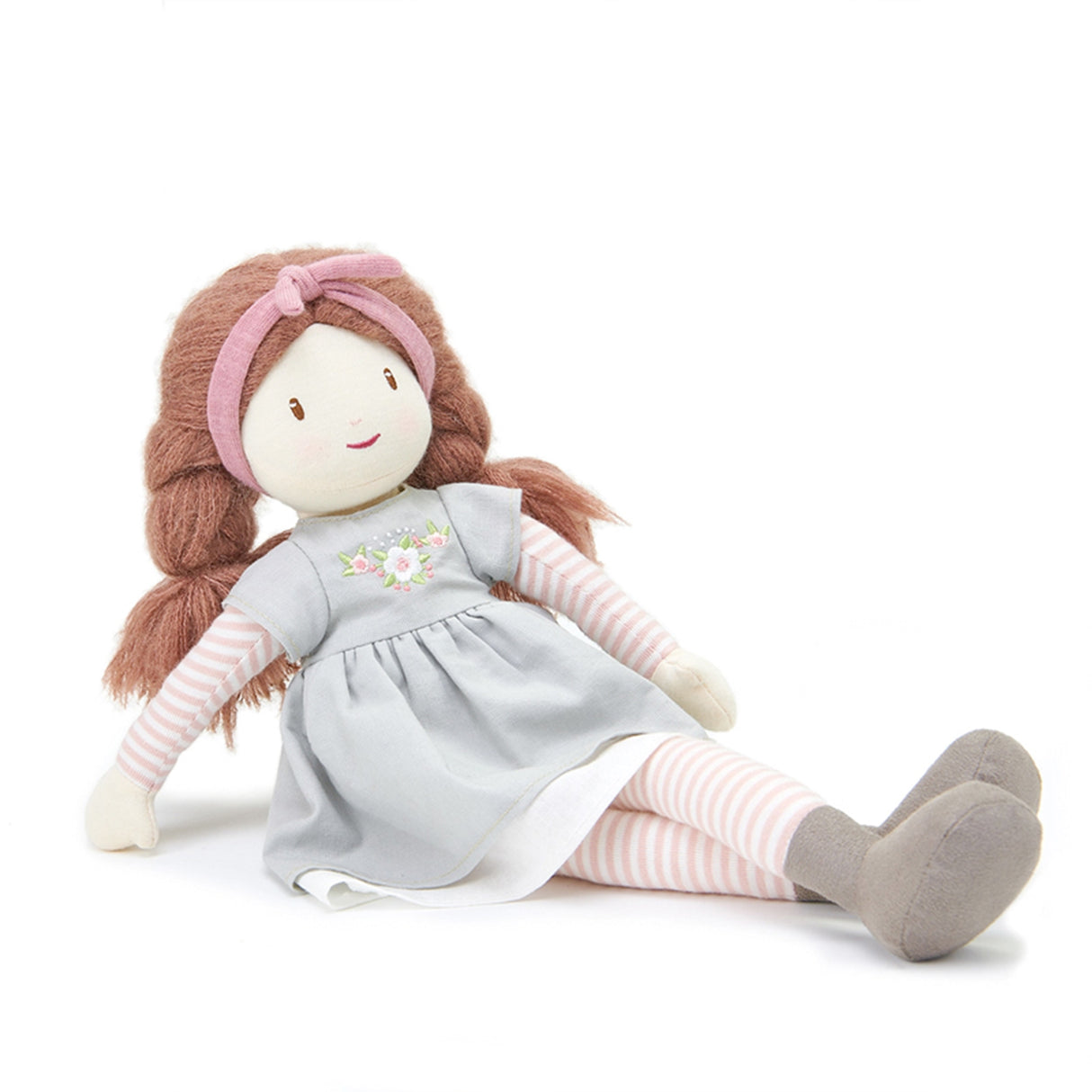 Stuffed doll with brown hair, pink headband, and gray dress on a white background